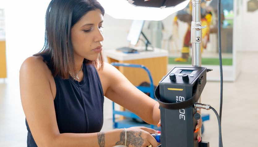 Photograph of a person adjusting film equipment. 