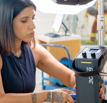 Photograph of a person adjusting film equipment. 