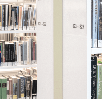 Photograph of bookshelves filled with various books.