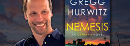 Gregg Hurwitz and a copy of his book Nemesis