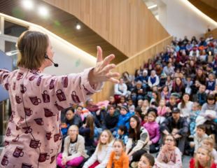 A photograph of a Library staff member hosting storytime in the Welcome Gallery at Central Library.