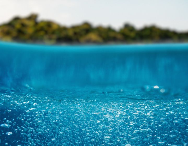 background image: An ocean with an island in the distance.